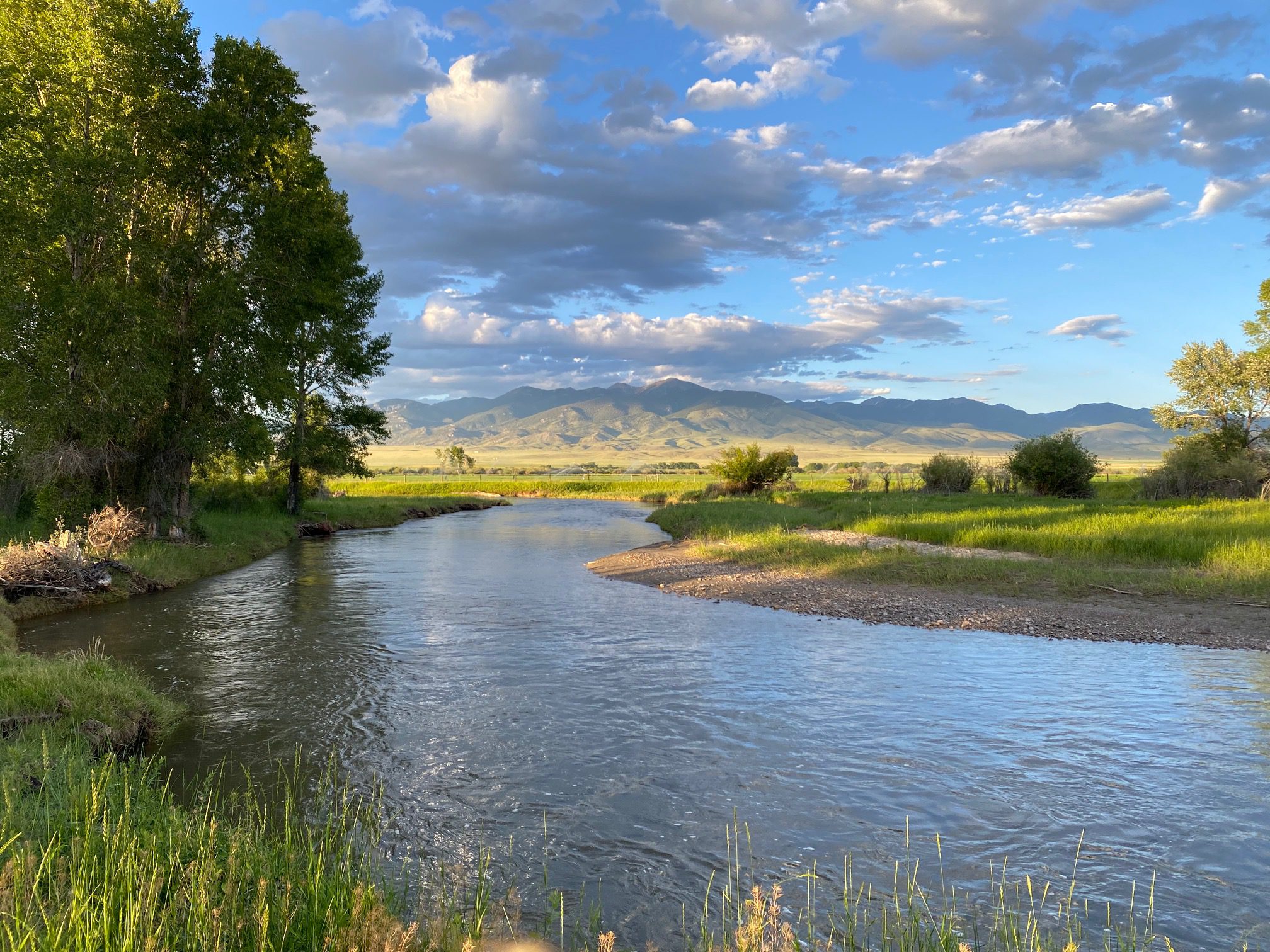 Peaceful winding river in front of mountain at Ruby Drake Lodge