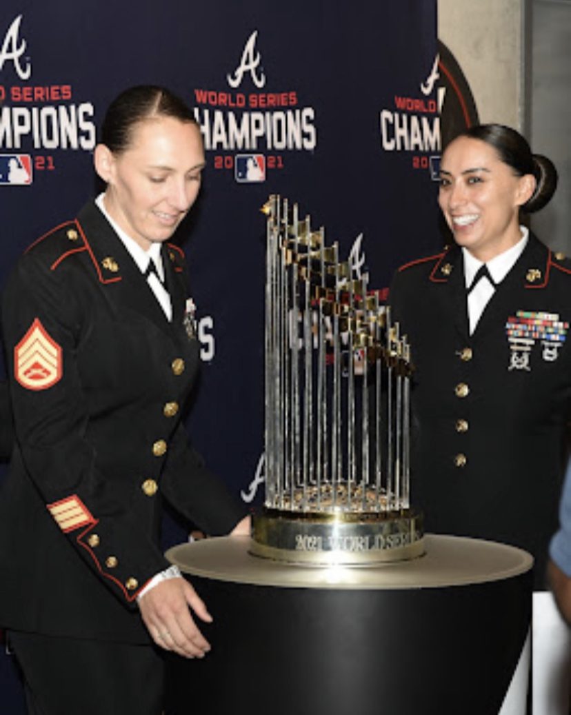 The Warrior Alliance Guests posing in front of the 2021 World Series Championship Trophy